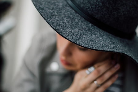 selective focus photography of woman wearing black hat thumbnail