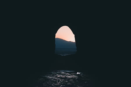 cave near silhouette of mountain thumbnail