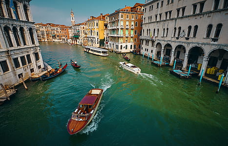 boats on river between buildings thumbnail