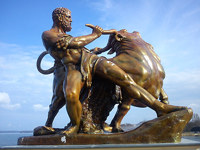 man with bull statue under blue sky thumbnail
