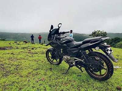 Black Backbone Motorcycle Near Man in Blue Shirt at Daytime thumbnail