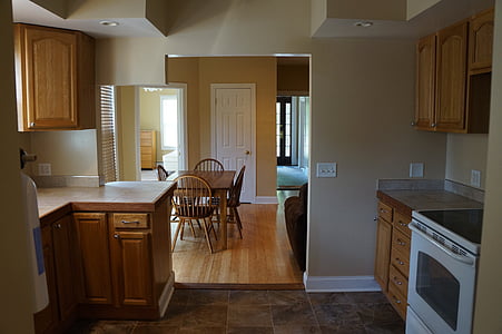 white induction range oven beside brown wooden kitchen cupboard thumbnail