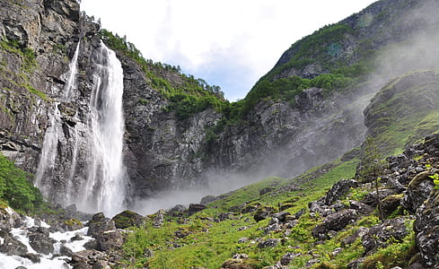 waterfalls on gray cliff during daytime thumbnail