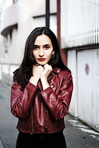 woman wearing a maroon leather jacket thumbnail