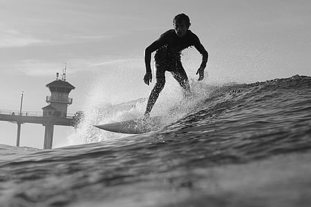 grayscale photography of man surfing on sea thumbnail