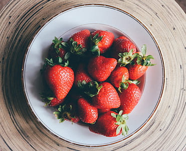 pink strawberry fruits on round white ceramic plate thumbnail
