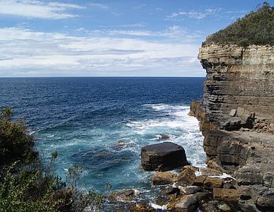 gray and brown cliffs near ocean thumbnail