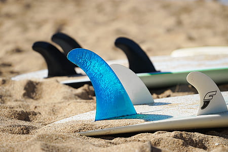 three surfboards on beach sands thumbnail