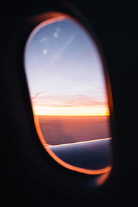 passenger plane window during dawn thumbnail
