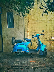Teal Motor Scooter on Road thumbnail