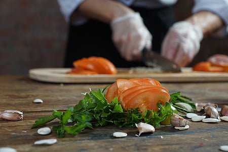 sliced tomatoes and green vegetables on table thumbnail