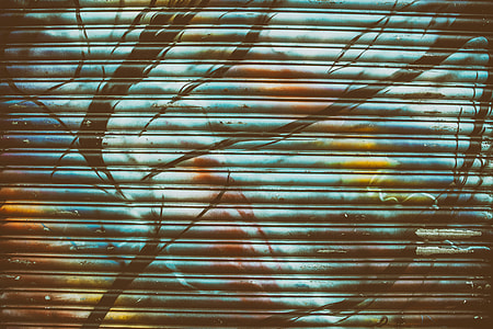 Wide angle shot of multi-coloured metal shop shutter thumbnail