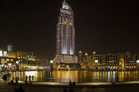 group of people sitting near body of water thumbnail