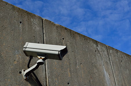 gray bullet-style security camera on wall thumbnail