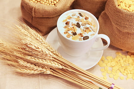 white ceramic mug with cereal near brown wheat and brown socks thumbnail