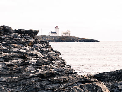 rock formation beside body of water thumbnail