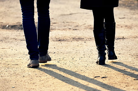 two people walking on gray road thumbnail