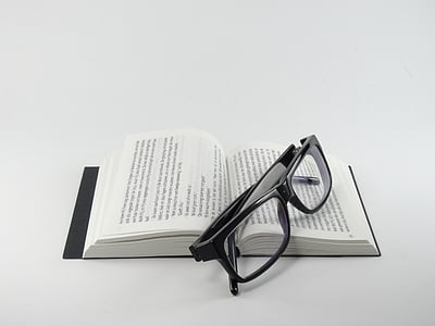 eyeglasses with black frames on opened book thumbnail
