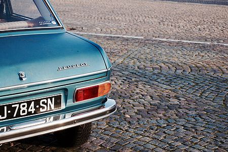 street photography of classic blue Peugeot car thumbnail