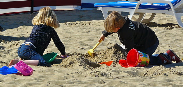 two children crawling on sand thumbnail