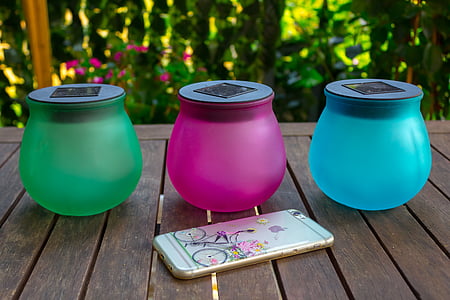 three assorted-color glass jars on brown wooden table thumbnail