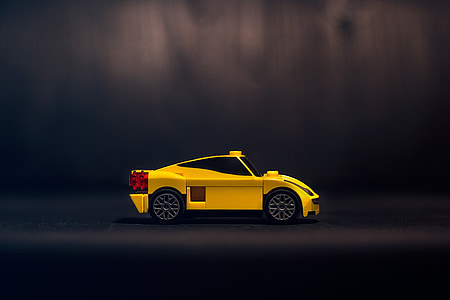yellow sports coupe isolated on black background thumbnail