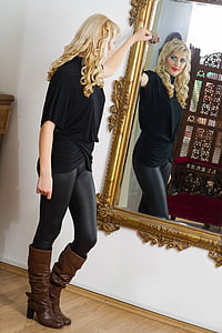 woman looking her reflection on the mirror thumbnail
