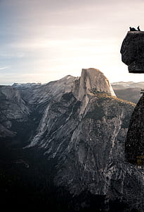 man ling above cliff during daytime thumbnail