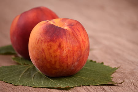 two red apples on table with leaf thumbnail