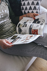 Woman reading a designer magazine on a couch thumbnail