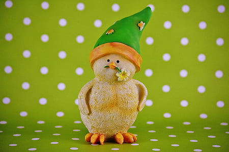 duckling biting yellow petaled flower figurine on green and white polka-dot surface thumbnail