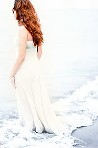 woman standing on beach during daytime thumbnail
