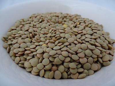 green and beige squash seed on round white ceramic bowl thumbnail