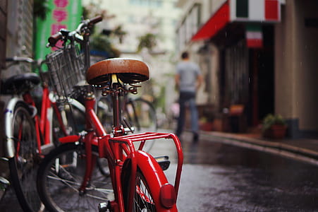 selective focus photo of red bicycle thumbnail