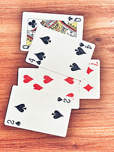 five assorted-print playing card on brown surface thumbnail