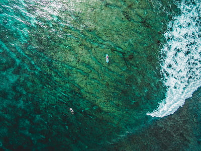 aerial photography of two surfers on sea thumbnail