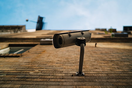 selective focus photography of bullet security camera on brick wall thumbnail
