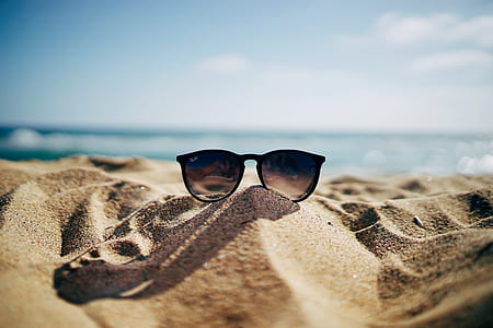 black framed Ray-Ban cat eye sunglasses on the sand thumbnail