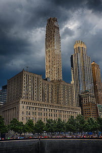beige concrete buildings beside trees thumbnail