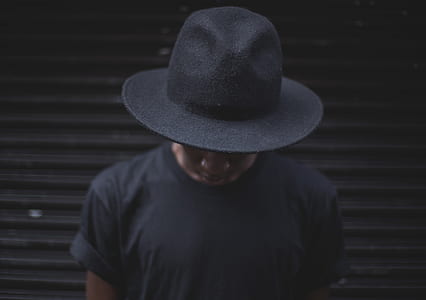 man standing near black pull-up door thumbnail