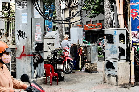 man standing beside electric source box thumbnail