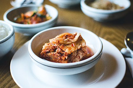 Kimchi in a white bowl close up thumbnail