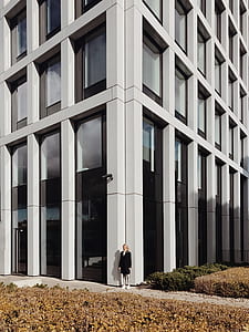 woman wearing blazer standing at the corner of concrete building thumbnail