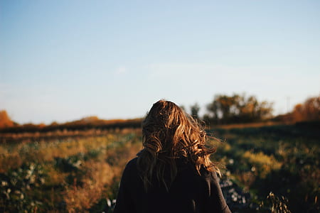 brown-haired woman near green grass field thumbnail