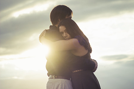 man and woman holding each other under sunset thumbnail