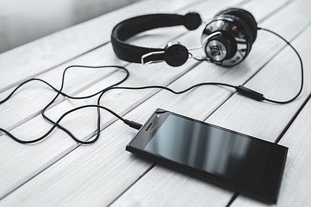 Black smartphone and headphones with various items thumbnail