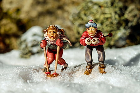 two woman snow skiing on white textile figurines thumbnail