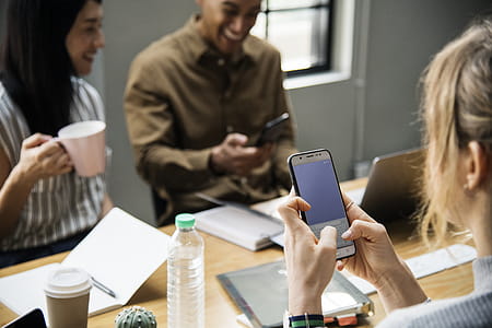 Woman Holding White Smartphone With Black Case thumbnail