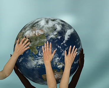 human hands holding earth scale model thumbnail