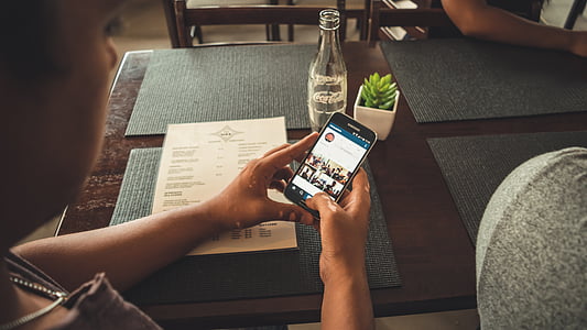 person using smartphone sitting on chair thumbnail